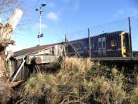 The bufferstop of the former Kinross bay platform (trains had to <br>
reverse onto and off the branch until its closure in 1950) is visible <br>
in the stationmaster's garden at Ladybank, where trees have been removed <br>
from the up sidings.<br><br>[John Yellowlees 06/02/2013]