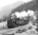 Giesl ejector fitted 0-6-2RT No. 97.208 eases the 09.39 empties from Vordernberg downhill at Feistawiese on 14 April 1976, with sister locomotive No. 97.201 providing additional braking assistance at the rear of the train.<br><br>[Bill Jamieson 14/04/1976]