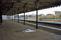 An easterly view under the extensive down platform canopy at Newmarket station on 27th March 1978. Built to shelter the large crowds that used to arrive at the station on race days, it had become redundant by the time this photo was taken and demolition was not far off. The 'bus shelters' seen on the opposite platform were already proving quite adequate for the remaining custom.<br><br>[Mark Dufton 27/03/1978]