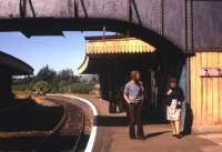 The photographer's brother and mother await the train for Marks Tey at Sudbury in June 1975. A few months later, while undertaking a post-graduate transport degree at the Polytechnic of Central London (PCL), the photographer found himself part of a team looking at a proposal to convert the Sudbury branch to a roadway. The team's report did not support such a conversion.<br><br>[David Spaven /06/1975]