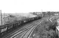 One of a pair of Claytons leaves a smokescreen over Motherwell shed as it passes by on a northbound freight in 1970. The train is passing the remains of the old coaling stage with the turntable visible on the extreme left of the picture. <br><br>[John Furnevel 30/10/1970]