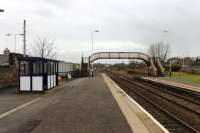 Looking west from Wigton towards Aspatria and Maryport in February 2013. The still operational BR signal box is sited some distance beyond the station itself. Just to the left of the platform shelter the roof of one of the buildings in the <I>Innovia</I> factory complex can be seen. This is still rail connected but doesn't receive any traffic at the present time.<br><br>[Mark Bartlett 03/02/2013]