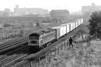 Non-boiler Brush Type 4 No. 47364 on the up slow line opposite the former shed yard at Mirfield with a short westbound container train in October 1982. The presence of another photographer indicates that something special was afoot, with 'Duchess' No. 46229 due to pass on its way from York to Chester to work the <I>Welsh Marches Pullman</I> later that day [see image 33861]. <br>
<br><br>[Bill Jamieson 23/10/1982]