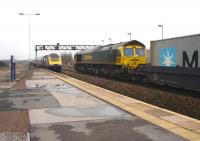 Freightliner 66594 awaits a First Great Western HST clearing Swindon Station with the 09.59 to London on 12 February to allow it to proceed with its consist of containers. <br><br>[David Pesterfield 12/02/2013]