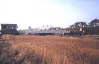 A DMU about to cross Reedham swing bridge, Norfolk, in March 1992. <br><br>[Ian Dinmore /03/1992]