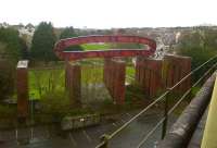 That loop of welded steel is supposed to look like part of a ship. It spans three piers of the deckless viaduct which lies West of Plymouth station and once carried a branch line down to the docks.<br><br>[Ken Strachan 10/02/2013]