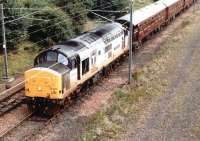 Transrail liveried 37406 <I>The Saltire Society</I> leaves Millerhill yard for Waverley in September 1997 with the empty stock of 'The Royal Scotsman'.<br><br>[John Furnevel 12/09/1997]