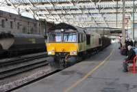 The Carlisle New Yard to Chirk logs train rumbles through Platform 4 of Citadel station on 25 February behind Colas Rail 66850. The smell of newly cut wood lingered under the overall roof for a long time after this lengthy train had passed. An Ayrshire bound coal empties train stands in Platform 3 waiting for a northbound path. <br><br>[Mark Bartlett 25/02/2013]