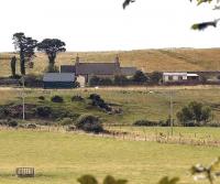 The closed station at Loth on the Far North line between Brora and Helmsdale. View east across fields in August 2007 - the coast lies just over the hill.<br><br>[John Furnevel 27/08/2007]