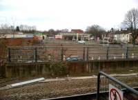 The view east from platform 7 at Nuneaton in February 2013. This barren site once supported a pub (the Grazier's Arms). The pub was demolished to build flats; but since property values have fallen by up to 30% in recent times, new flat building is untenable. The debate is now whether to build a drive-through fast food outlet, or a new rear entrance to the station. (Either scheme would affect the 'informal' station parking demonstrated by the cars just beyond the wall.)<br><br>[Ken Strachan 03/02/2013]