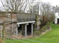 Burgh-by-Sands station closed with the Silloth line in 1964. On the west side of the village this bridge still crosses the old line but  local homeowners have extended their gardens over the trackbed.<br><br>[Mark Bartlett 03/02/2013]