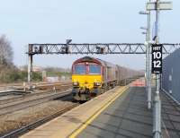 Platform scene at Swindon on 4 March 2013 with 66154 passing through with coal empties heading towards Bristol.<br><br>[Peter Todd 04/03/2013]