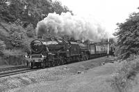 Scene at Apperley Bridge on the ex-MR main line between Leeds and Shipley with The LCGB Fells and Dales railtour returning to Carnforth on 19 June 1976. Preserved Black 5 No 45407 + B1 No. (6)1306 are double heading the train.<br><br>[Bill Jamieson 19/06/1976]