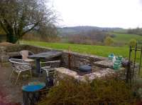 A cut-down passenger waiting shelter on the Southbound platform at Wellow in April 2012 - no doubt a nice place to sit out and relax on summer evenings. [See image 38866]<br><br>[Ken Strachan 06/04/2012]