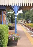 Platform scene at Lingwood station, Norfolk, on the line between Norwich and Great Yarmouth, on a warm summer's day in June 2010. The view is east towards the level crossing over Station Road.<br><br>[Ian Dinmore /06/2010]