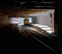 Glasgow bound 303 pausing at Dalmarnock in June 1987 before entering the gloom.<br><br>[Ewan Crawford 12/06/1987]