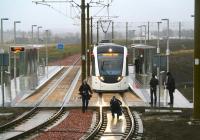 Centre of attention. Scene at Ingliston Park and Ride on a wet 8 March 2013 during the Edinburgh Trams event marking handover of the first section of the route from the contractors to Edinburgh City Council. View is east towards Gogarburn. [See image 42296]<br><br>[John Furnevel 08/03/2013]