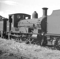 The shed yard at Eastleigh in August 1960, with Beattie 2-4-0WT no 30585 in the sidings. The 1874 veteran was withdrawn from Wadebridge (72F) at the end of 1962. No 30585 is now preserved and operational at the Buckinghamshire Railway Centre, Quainton Road.<br><br>[K A Gray 09/08/1960]