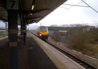 South to Glasgow! This Birmingham - Glasgow Voyager was diverted via Nuneaton and Leicester instead of its normal route north of Birmingham. As it passed through platform 7 non-stop - an unusual move even for freight trains - the young lady behind the second pillar had very wisely stepped away from the platform edge. The industrial buildings on the right are built on an area formerly used for sidings. Network Rail - reinstated Leicester-Birmingham flyover line<br><br>[Ken Strachan 03/02/2013]