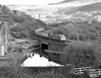 40084 approaches the east end of Standedge Tunnel with the 13.49 York to Liverpool Lime St. service in 1980. At the time Trans-Pennine expresses were primarily operated by class 47s, so the appearance of an EE Type 4 probably indicates a loco failure shortly before departure from York. <br>
<br><br>[Bill Jamieson 11/11/1980]