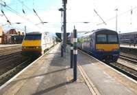 A Kings Cross - Newcastle train calls at Doncaster on 12 March 2013. In the north end bay platform alongside is former North Berwick unit 322485, waiting to depart with the shuttle service to Leeds.<br><br>[John McIntyre 12/03/2013]