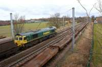 Freightliner 66520 heads north passed Oxheys Loop with empty coal wagons to Killoch from Fiddler's Ferry Power Station on 14 March 2013. In the loop are a number of single and double deck car carriers which had been removed from the 6O15 Mossend to Eastleigh freight in the early hours of 13 March.<br><br>[John McIntyre 14/03/2013]