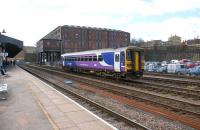 Single car 155317 in the sidings to the north of Huddersfield station on 12 March 2013 with the imposing former goods warehouse behind.<br><br>[John McIntyre 12/03/2013]