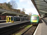 158835 stands at Shrewsbury on 14 March with the 11.33 Arriva Trains Wales ex-Cambrian Coast 6 car limited stop service to Birmingham International.  Alongside is 170633, which will follow as the 11.47 London Midland all stations service to Birmingham New Street.<br><br>[David Pesterfield 14/03/2013]