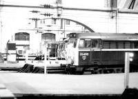 View from the station concourse at Kings Cross over the buffer stops in 1981. Nearest the camera 31402 has recently arrived with empty stock. Alongside is a class 312 EMU about to depart on a Royston service. Furthest away is 31405, another locomotive engaged in empty stock duties.   <br><br>[John Furnevel 13/01/1981]