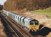 Freightliner 66548 with empty HTAs heading west from Longannet to Hunterston near Plean on 17 March 2013.<br><br>[Brian Forbes 17/03/2013]