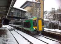 The 13.22 to Worcester Foregate Street adds a bit of colour to the heavy rail side of Birmingham's Jewellery Quarter station on 24th March. The arch just visible to the right of the lamppost does not appear to be a railway relic.<br><br>[Ken Strachan 24/03/2013]