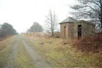 A misty morning at Ardler Junction looking east in 1997. The main line towards Forfar ran straight ahead with the route south to Dundee via Newtyle diverging to the right. The signalbox stood alongside the small brick hut.<br><br>[Ewan Crawford //1997]