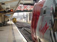 158818 stands at the west end of platform 3 at Chester on 27 March during reversal of the 13.08 ex Birmingham International to Llandudno & Holyhead service. The Virgin Voyager in the foreground will lay over for another 70 minutes before forming the 16.35 departure to London Euston.<br><br>[David Pesterfield 27/03/2013]