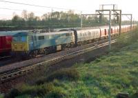 The Glasgow portion of the 'postal' arriving at Carstairs in 1988 behind 86239 <I>L S Lowry</I>. Beyond is the Edinburgh portion brought in earlier by 47653. The trains will combine before heading south. Sadly, some 8 years later on 8 March 1996, at Rickerscote south of Stafford, no 86239, again hauling a TPO, was in collision with a derailed freight train. The accident led to the death of a Royal Mail sorter and injured 22 others. 86239 was withdrawn and subsequently cut up following the accident. [See image 42543]<br><br>[Ewan Crawford //1988]