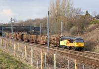 A resplendent Colas Rail Freight Class 56 southbound near Farington Curve Junction on 27 March 2013.  No 56106 is hauling 15 loaded timber wagons from Carlisle to the Kronospan factory at Chirk.<br><br>[John McIntyre 27/03/2013]
