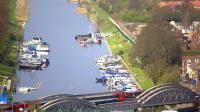 A Nottingham - Skegness train crossing the bridge over the River Witham at Boston Sluice in April 2012. Long lens view taken from St Botolph's Church tower.<br><br>[Ian Dinmore /04/2012]