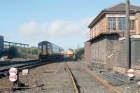 A southbound train approaching Larbert in the 1990s passing a class 26 in the sidings alongside the north box.<br><br>[Ewan Crawford //]