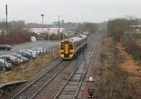 A Glasgow Queen Street - Falkirk Grahamston service, formed by unit 158718, pulls away from Cumbernauld station on 8 March 2013. The train is passing the turnback siding and crossover used by the Motherwell shuttles. <br><br>[Mark Bartlett 08/03/2013]