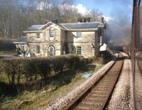 The former station building at Castle Howard between Malton and York, seen from a passing train on 3 April 2013. Opened in 1845 to serve the large country house of the same name, it closed to passengers in 1930. The connection with the estate of the Earl of Carlisle resulted in the ornate station building.<br><br>[John McIntyre 03/04/2013]