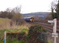 A 158 running south between bath and Weymouth [see image 42584] approaches Glasses Crossing on 30 March. Does this mean it is about to make a spectacle of itself? View north east, with the GW main line hidden by the hedge on the far side of the Weymouth line.<br><br>[Ken Strachan 30/03/2013]