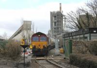 Having left Mossend at 0658, and travelled via Beattock and the S&C, it is now 1210 and 66105 propels a rake of empty cement tankers under the loading facility at the Castle Cement Works at Horrocksford near Clitheroe. This view taken from the West Bradford Rd level crossing. [See image 30807] for the view along the branch in the opposite direction.<br><br>[Mark Bartlett 05/04/2013]