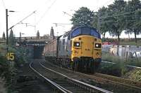 In the 1970s, apart from holiday excursions, the only regular diesel hauled train on the Colchester - Clacton line was the early morning newspaper service which ran every day except Sunday. It is seen here at 6.30am on 7th July 1979 passing under Cowdray Avenue in Colchester on its return leg. In the foreground are the points for the <I>flyunder</I> junction to the main line.<br><br>[Mark Dufton 07/07/1979]