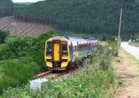 A train from the far north bound for Inverness seen shortly after leaving Rogart on 25 August 2007. The train is heading west towards Lairg at this stage with the A839 road running parallel on the right. [See image 42675] <br><br>[John Furnevel 25/08/2007]