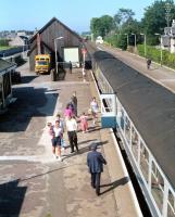 An Aberdeen - Inverness train at Nairn in 1990. In the background a class 37 hauled freight is held until the signalman completes his cycle journey from the east box to the west box.<br><br>[Ewan Crawford //1990]