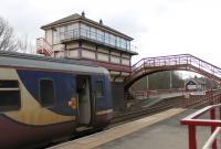 Haltwhistle's elevated signalbox and the footbridge that links the staggered platforms. Northern Sprinter 156468, on a Newcastle bound service, has just arrived from Carlisle.<br><br>[Mark Bartlett 25/02/2013]