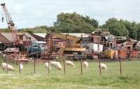 The road approach to Annan Shawhill station in 1998 with the scrapyard that grew up around the old station (closed in 1931) dominating the scene. Atop the pile of scrap is Fowler 0-4-0DH 22971 of 1942, previously used by the MoD at Eastriggs [see image 11561]. The locomotive is now preserved on the Eden Valley Railway at Warcop. [With thanks to all who responded to this query]<br><br>[Ewan Crawford //1998]