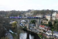 Performing the hourly ritual of reversing onto the viaduct at Knaresborough and then setting back into the station is a Northern 153/155 Sprinter combination. Every other train from Leeds terminates here with the alternates continuing to York. The quirky signalbox is on the right overlooking the bridge.<br><br>[Mark Bartlett 19/04/2013]