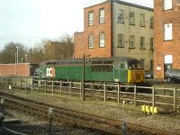 Devon & Cornwall Railway liveried 56303 is stabled in the down side north end loading dock siding by Derby Station on the morning of 16 April 2013.<br><br>[David Pesterfield 16/04/2013]