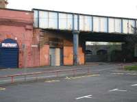 Looking north at the top of Molendinar Street in 2007, with Gallowgate behind the camera. The bridge carries the CGU line between Saltmarket Junction and High Street East Junction. Round the corner under the bridge is the former entrance to Gallowgate station (closed as long ago as 1902). In the right background on the north side of Bell Street is the urban viaduct that once carried the lines into College goods depot, the huge warehouse of which still stands as flats [see image 14886].<br><br>[John Furnevel 06/05/2007]