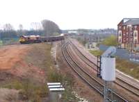 Captured at last. View east as 66117 turns off the Birmingham line onto the North chord at Nuneaton on 25 April 2013. I believe this is a sand train from Whitemoor yard to Carlisle. Notice the Freightliner in the right background stopped at platform 6 - most likely for a driver change. [See image 42863]<br><br>[Ken Strachan 25/04/2013]